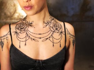 Jagua tattoo of peony and chain design on female chest