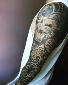 Jagua tattoo stain on male in Japanese dragon sleeve style