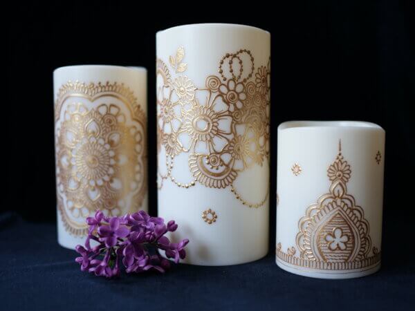 Set of 3 LED candles in various sizes, hand painted with designs in metallic gold