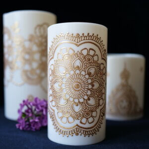 Set of 3 LED candles in various sizes, hand painted with designs in metallic gold