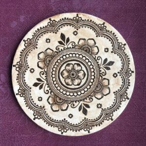 circular canvas with floral mandala painted in henna paste