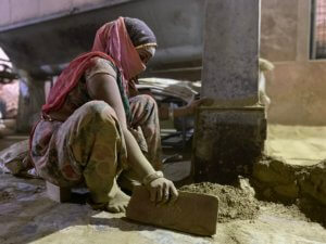 Woman in Henna Grinding Room